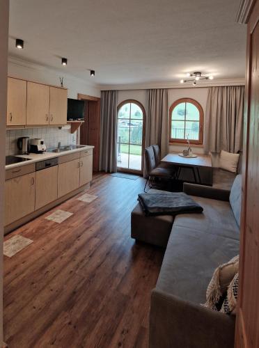a large living room with a couch and a table at Appartementhaus Unterkofler in Grossarl