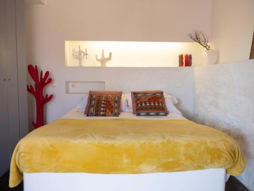 a bedroom with a bed with two pillows on it at GoToGeres - Casa da Eira - Sobrenatura in Arcos de Valdevez