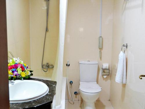 a bathroom with a white toilet and a sink at Dancenter Top Star Heritage Village in Abu Dhabi