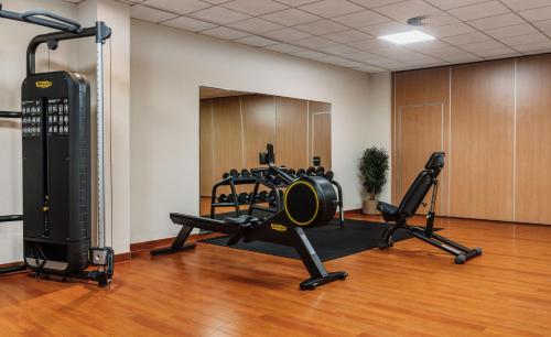 a gym with two treadmills and weights in a room at IFA Graal-Müritz Hotel & Spa in Graal-Müritz