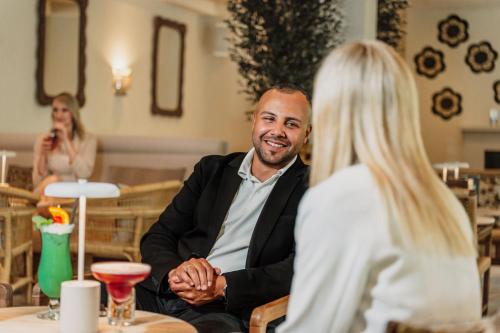a man and a woman sitting at a table at IFA Graal-Müritz Hotel & Spa in Graal-Müritz