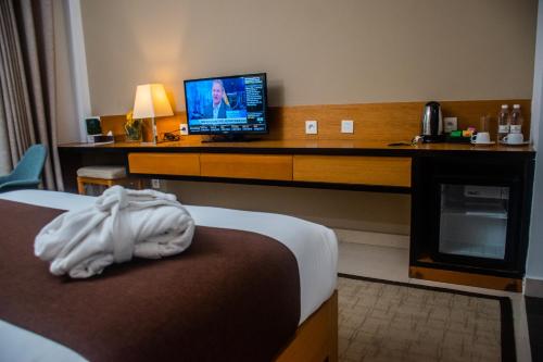 Una cama o camas en una habitación de Pefaco Hotel Maya Maya