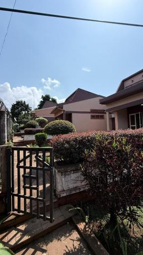 a wooden bench sitting in front of a house at Peaceful 2-Bedroom Home in Kla in Nalakonge