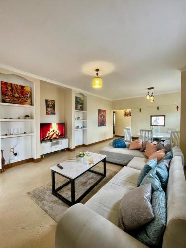 a living room with a couch and a fireplace at Peaceful 2-Bedroom Home in Kla in Nalakonge