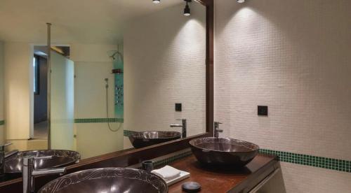 a row of sinks in a bathroom with a mirror at Luxurious Villa with Ocean Views in Pointe Milou in Pointe Milou