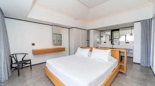 a bedroom with a bed and a desk and a chair at Luxurious Villa with Ocean Views in Pointe Milou in Pointe Milou