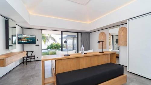 a bedroom with a bed and a desk at Luxurious Villa with Ocean Views in Pointe Milou in Pointe Milou