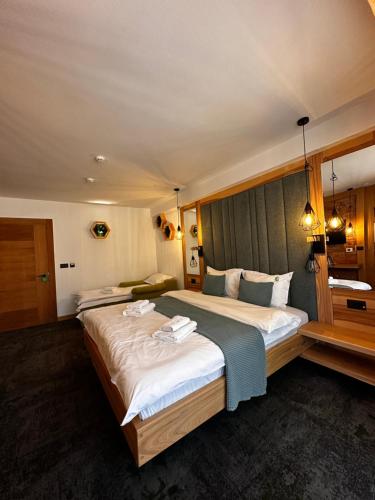 a hotel room with a large bed in it at Forest Green & Spa in Gura Humorului