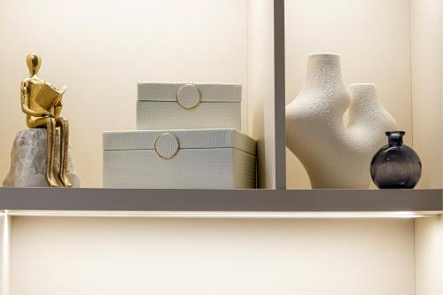 a shelf with vases and boxes on it at The Mini Resort in Prinos