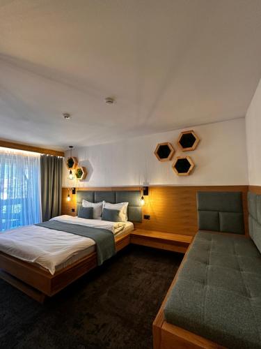 a bedroom with a large bed and a window at Forest Green & Spa in Gura Humorului