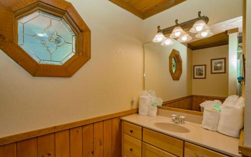 a bathroom with a sink and a stained glass window at Treetop Retreat in Gatlinburg