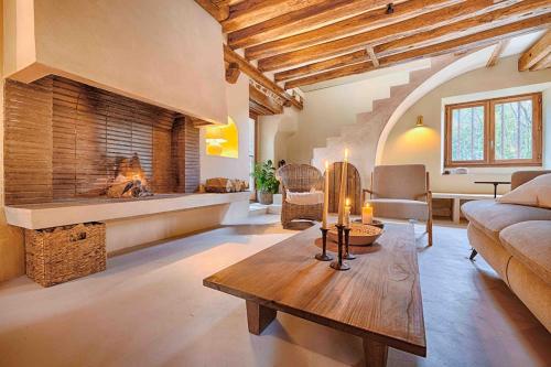 a living room with a couch and a fireplace at Le Moulin de Rochopt in Boussy-Saint-Antoine