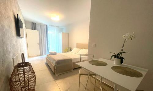 a living room with a bed and a table in a room at Villa Nina in Lagosanto