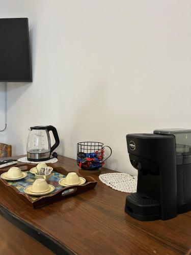 a table with a coffee maker and plates on it at Mesciu Cesare B&B in Lecce