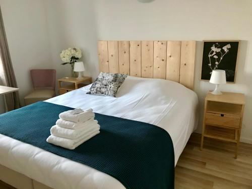 a bedroom with a bed with towels on it at Domaine du Haut-Koenigsbourg in Orschwiller
