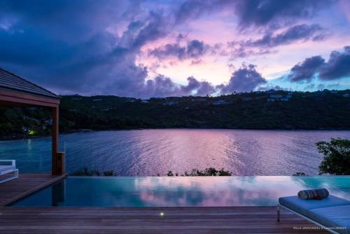 a swimming pool with a view of a lake at Luxury Villa with Ocean Views in Marigot in Marigot