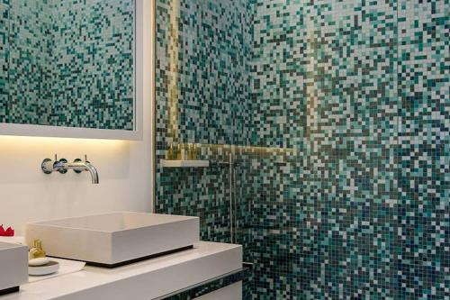a bathroom with a sink and a glass shower at Luxury Villa with Ocean Views in Marigot in Marigot