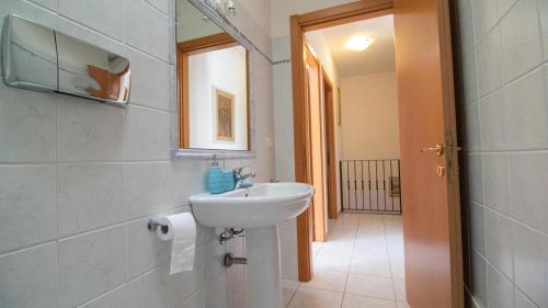 a bathroom with a sink and a mirror at Domus Peppi in Villasimius