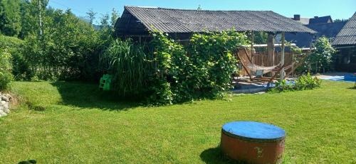 a garden with a gazebo and a blue barrel at Królówka in Maków Podhalański