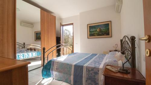 a bedroom with a bed and a balcony at Domus Peppi in Villasimius