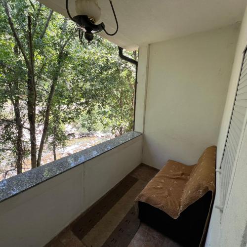 an empty room with a window and a bench at Villa Gryka in Peje