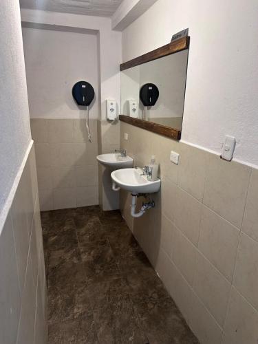 a bathroom with two sinks and a mirror at W i M, Hostel & Camping in Chaupi
