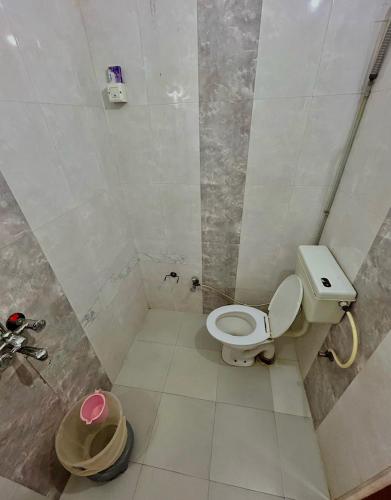 a small bathroom with a toilet and a shower at Golden Marigold Hotel in Jaisalmer