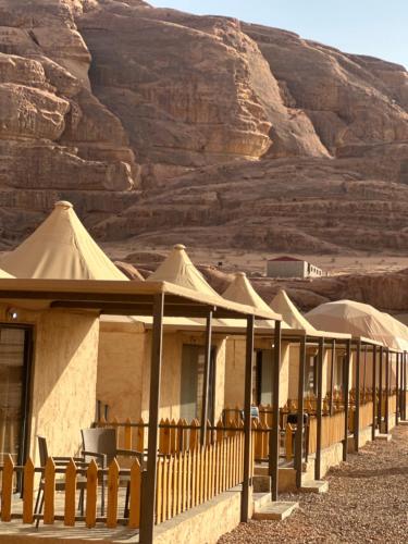 a row of tents in the desert at Rum relaxation luxury camp in Wadi Rum