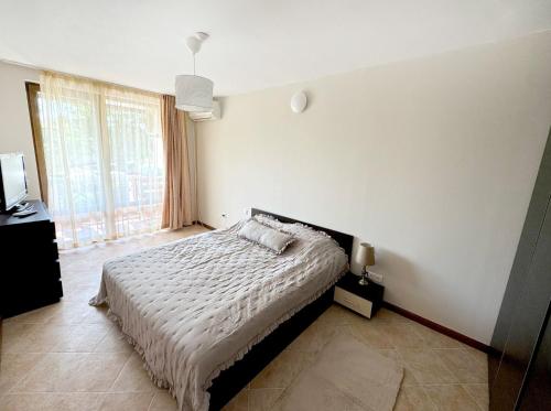 a bedroom with a bed and a large window at Casa Oasis Lozenets in Lozenets