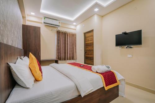 a bedroom with a bed and a flat screen tv at Boat Residency in Cochin