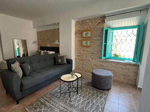 a living room with a couch and a window at My Symi Apartments in Symi