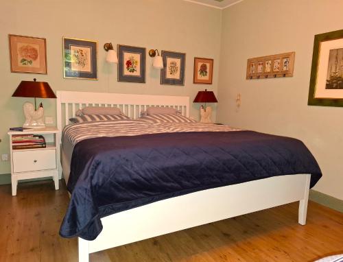 a bedroom with a large bed with a blue comforter at Gastehaus HH- Winterhude in Hamburg
