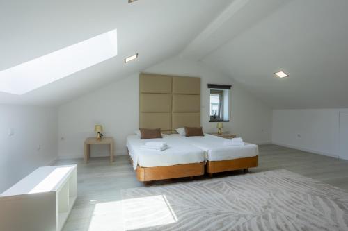 a bedroom with a large bed in a white room at Edificio Luisa Premium in Velas