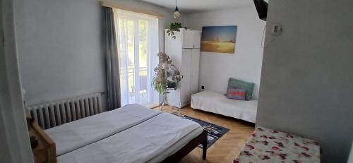a small room with a bed and a window at Królówka in Maków Podhalański