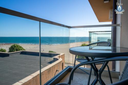 a balcony with a table and a view of the beach at Daria Boutique Hotel in Eforie Sud