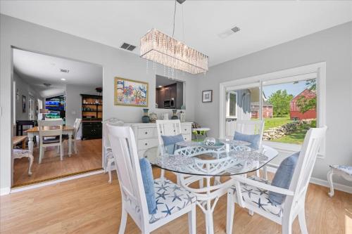 a dining room and living room with a table and chairs at Unique Retreat with Private Patio, 4 King Beds and BBQ in Groton