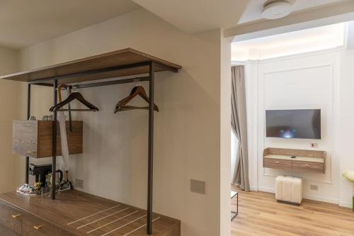 a living room with a room with a tv on a wall at Splendide Riviera Boutique Art Hotel in Rapallo