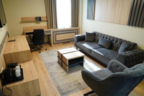 a living room with a couch and a table at Dafne Hotel in Ankara