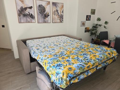 un letto con una trapunta floreale sopra. di Miriam's House - La casa di Miriam, zona centrale, 2 minuti a piedi dal Duomo di Como a Como