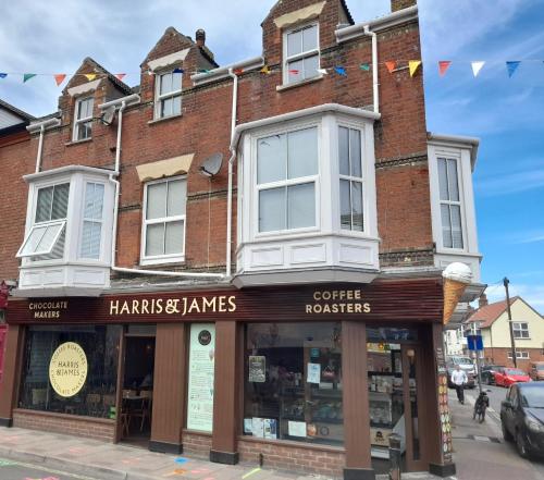 a building on a street with a coffee shop at BERNARDS HIDEOUT in Cromer