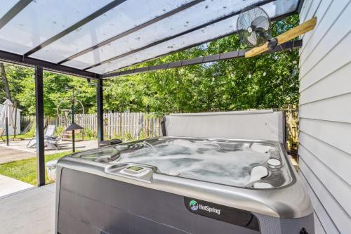 a hot tub in the backyard of a house at Spacious Family Getaway- Salt Water Pool & Hot Tub in Lyndhurst