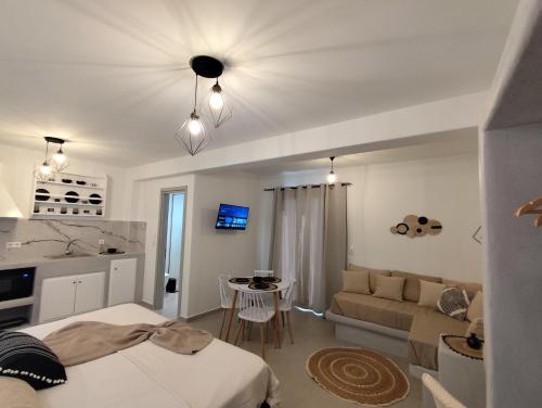 a bedroom with a bed and a living room at lemon in Agia Anna Naxos