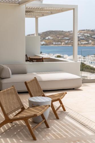 a living room with a couch and two chairs at Νumi Boutique Hotel in Mýkonos City