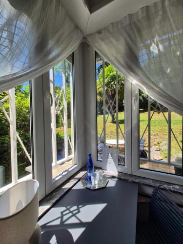 a room with windows and a table with a bottle on it at Résidence Souverain 94 in Brussels