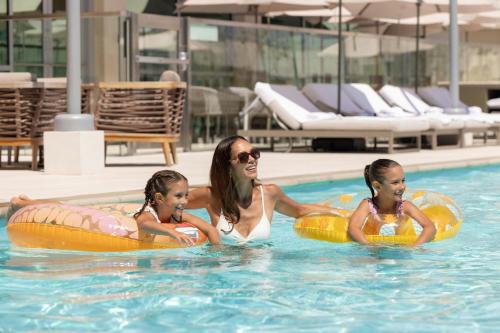 a woman and two girls in the swimming pool at JW Marriott, Anaheim Resort in Anaheim