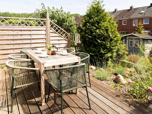 a wooden table and chairs on a deck at Lottes Hus in Lübeck
