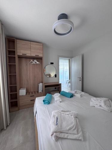 a bedroom with two beds with towels on them at Casa de Lapel Mola Kaliva in Mola Kalyva