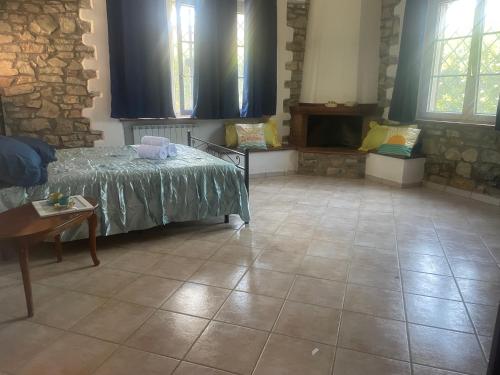 a room with a bed and a table and windows at Villa SUNSHINE in Sanfatucchio