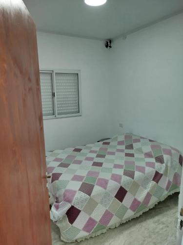 a bedroom with a bed in a white room at Quinta El sol in Reconquista