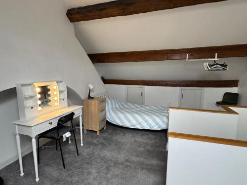 a bedroom with a desk and a bed in a attic at Sowerby apartments in Sowerby Bridge